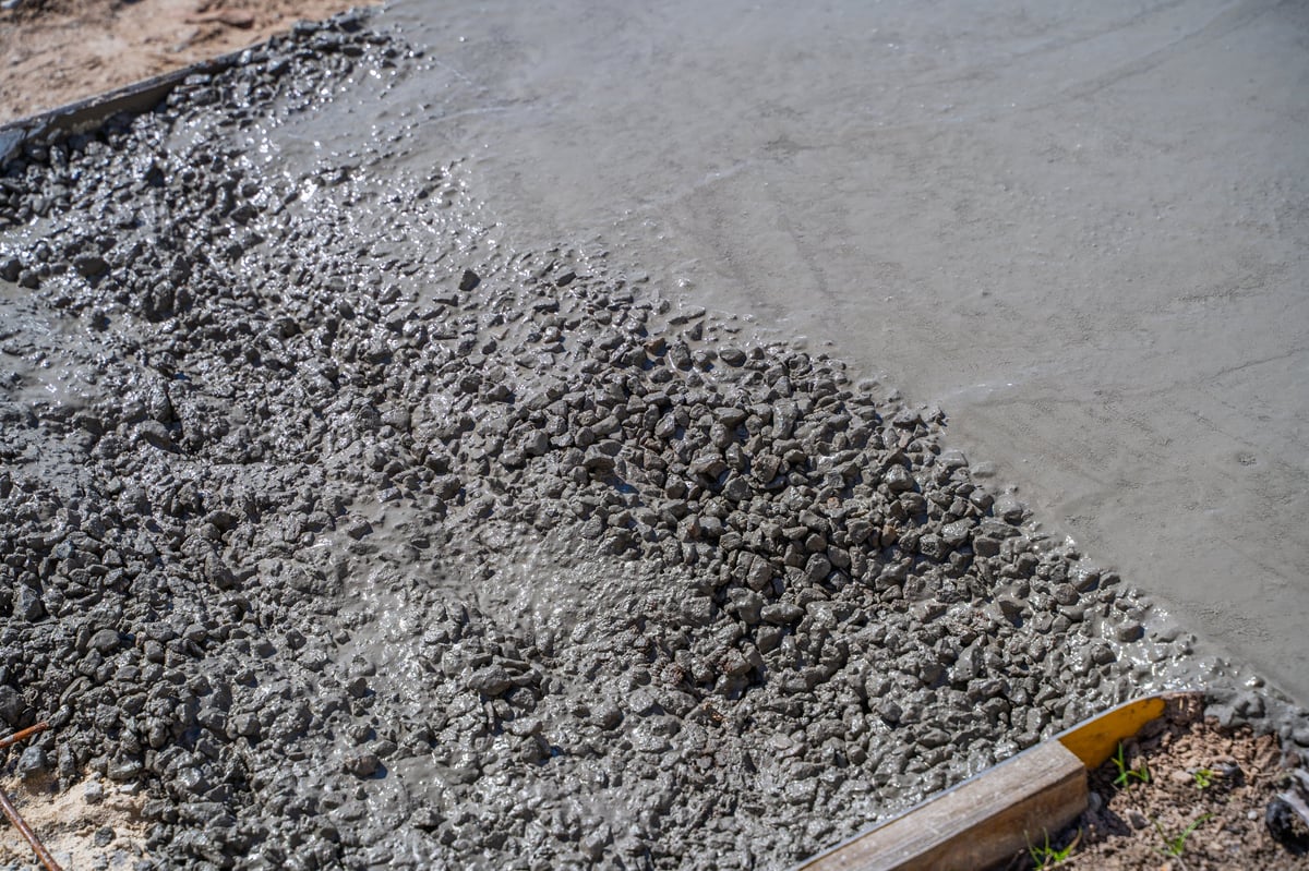 The process of pouring concrete on a path on a sunny day, close-up