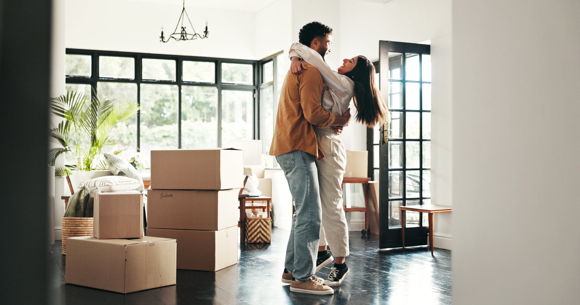 Happy couple in new house, moving and ownership of property