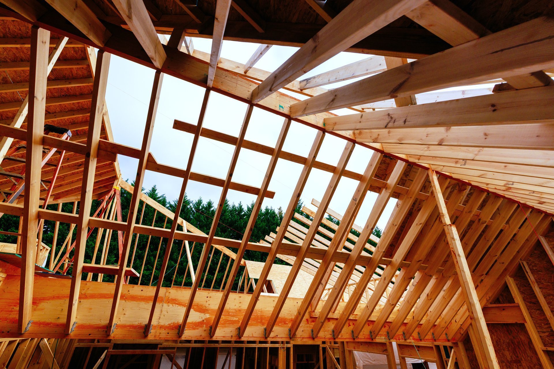 Workers are building wooden house frame, trusses roof supports studs joist overhead
